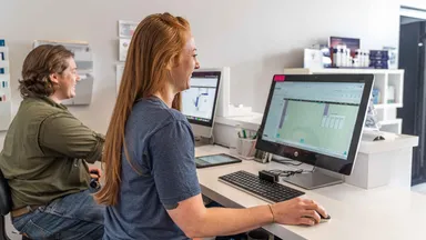 Two employees at the front desk